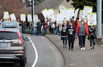 In this March 2022 file photo, hundreds of frontline nurses from the Providence Health System join supporters at an informational picket in front of the St. Vincent hospital in Portland. Nurses have now agreed to a contract with the health care giant.