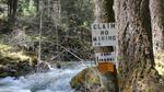 A woman has posted a sign staking her mining claim on federal land next to the Middle Fork Applegate River in northern California. 
