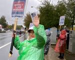 Pharmacy technician Liz Binder pickets on Southeast Sunnyside Road in front of the Kaiser Permanente Sunnybrook Medical Office in Clackamas, Ore., Oct. 25, 2023. Several outpatient pharmacies have been temporarily closed due to the strike, including at Sunnybrook.