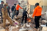 In this photo released by the Indonesian National Search and Rescue Agency (BASARNAS), rescuers attempt to clear debris at building damaged by an earthquake in Maumere, East Nusa Tenggara Province, Indonesia, Saturday, Aug. 15, 2026.