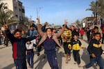 Children cheer in Nuseirat in the central Gaza Strip on January 19, 2025, shortly before a ceasefire deal in the war between Israel and the Palestinian militant group Hamas was implemented.