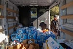 Dozens of volunteers based out of an old church youth center organize food and clothing supplies before heading out to the camps near Jacumba, Calif., on Nov. 11.