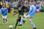 Portland Timbers midfielder George Fochive (20) plays the ball ahead of New York City FC midfielder Alfredo Morales (7) during the first half of the MLS Cup soccer match Saturday, Dec. 11, 2021, in Portland, Ore. (AP Photo/Amanda Loman)