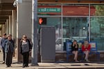 People wait at the intersection of Southeast Cesar E. Chavez Boulevard and Hawthorne Boulevard on March 27, 2026 in Portland, Ore.