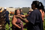 Mable Jackson (Modoc, Hupa) offers hugs and handshakes at the end of powwow at Two Rivers Correctional Institute in Umatilla, Ore., Aug. 24, 2019.