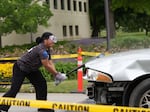 A student slams a baseball bat into a vehicle in Eastern Oregon University's annual "Car Smash" on June 3, 2026.