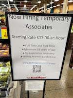 A hiring sign is seen inside a Fred Meyer store.