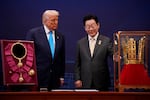 U.S. President Donald Trump reacts as he is presented with the Grand Order of Mugunghwa and the Silla gold crown by South Korean President Lee Jae Myung at the Gyeongju National Museum on October 29, 2025 in Gyeongju, South Korea.