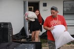 Payton Wyse (L) and Andrew Goncharsky pack what they can as they evacuate their apartment before Hurricane Milton's arrival on October 09, 2024 in Fort Myers, Florida. 