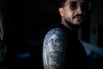 Ali Rida, a member of the Nabatiyeh paramedic team, poses for a portrait. He has a full-sleeve tattoo depicting characters from the movie The Godfather and the Statue of Liberty.