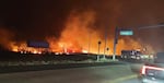 August 8: This photo provided by County of Maui shows fire and smoke filling the sky from wildfires on the intersection at Hokiokio Place and Lahaina Bypass in Maui, Hawaii.