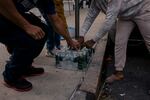 Migrants eagerly receiving soda and water bottles along with donated meals outside the Atlantic Armory Shelter in Brooklyn earlier this month.