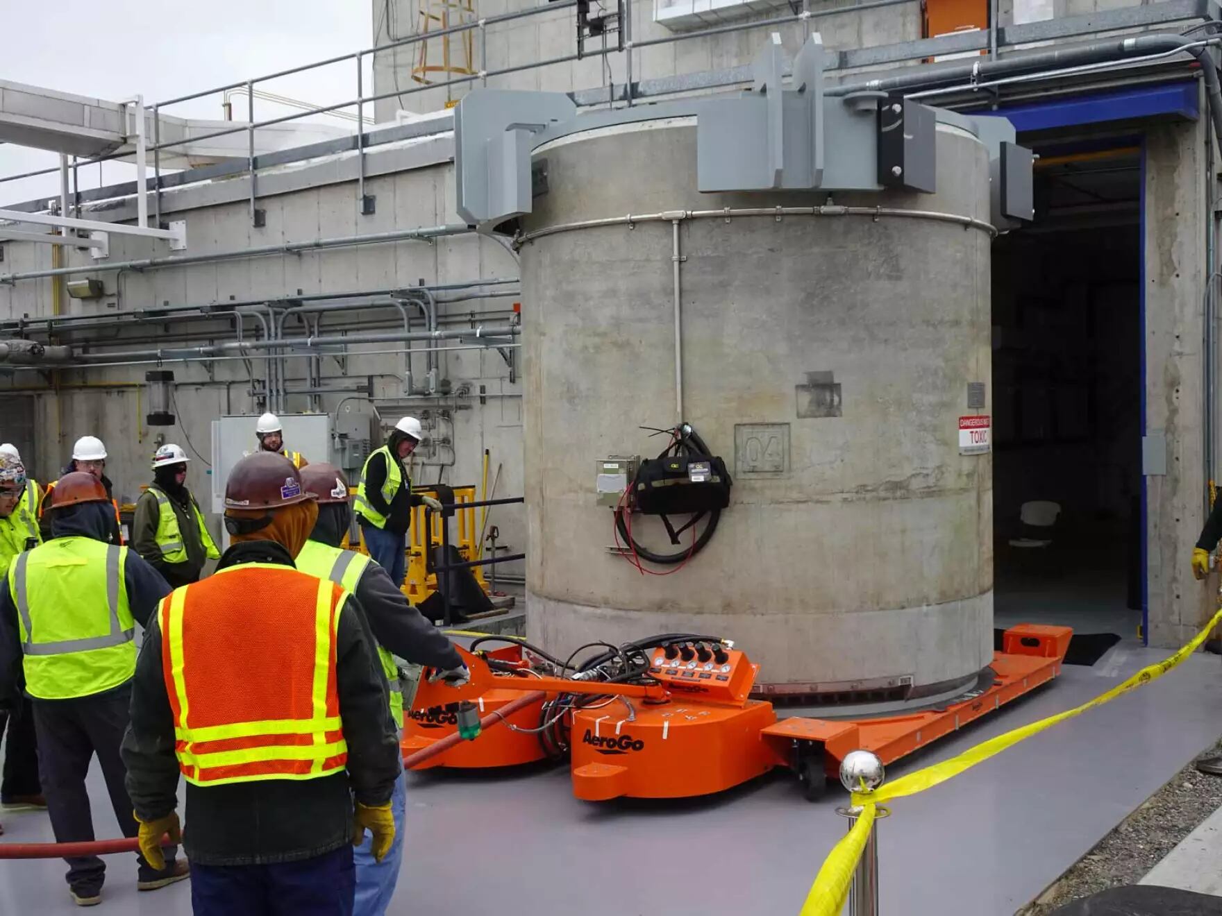 FILE - Workers move a newly-filled cask out of the Waste Encapsulation and Storage Facility on Jan. 20, 2026.