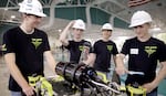 Warrenton students, from left, Owen Cross, Daniel Myrvold, Declan Wallace and Dalton Wallace gear up for an underwater robotics regional competition in Newport May 10. The team took first place and qualified for the world championship competition in June.
