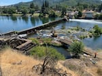 Construction crews working at Winchester Dam near Roseburg, Ore., on Monday, Aug. 7, 2023. Crews were lowering water above the dam to prepare to make repairs on the privately owned dam.