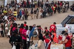 Migrants receive food and aid from the NGO's in El Trampolin Beach on August 14, 2026 in Ceuta, Spain.