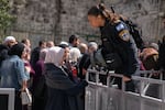 Israeli police check bags as they oversee the entrance to Al-Aqsa Mosque in Jerusalem's Old City on the first Friday of Ramadan, on March 15.