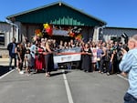 In this photo provided by the Latino Community Association, executive director Catalina Sánchez Frank cuts a ribbon in front of the nonprofit's Bend offices on May 30, 2025.