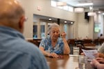 Dorene Rosenbaum, 87, looks at her dice roll at the Council on Aging in Bend, Ore., on Friday, Jul., 5 2024. Rosenbaum meets to play Farkle every Friday after lunch at the Council on Aging. It’s one of four designated cooling centers open in Bend on Friday during a statewide heat wave — however, the center is only open until 2 p.m., just as the day reaches it’s highest temperatures.