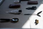 A display case holds items that were once owned by African American residents of New York City's tenements. They include a spoon, a magnifying glass and a collection of Abraham Lincoln's speeches.