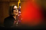 Oregon Governor Kate Brown next to a US flag.