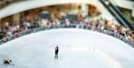 Vivienne Armyai, 16, left, leans low into the ice as she makes a pass around the rink as attendees clap and cheer.