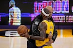 Kareem Abdul-Jabbar, left, hugs Los Angeles Lakers forward LeBron James after he surpassed Abdul-Jabbar to become the NBA's all-time leading scorer during the second half of an NBA basketball game against the Oklahoma City Thunder on  Tuesday in Los Angeles.