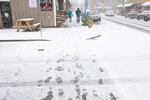 People slip and slide past Opa Pizzeria on 13th Avenue in the Sellwood neighborhood during a snowstorm in Portland, on Thursday, Dec. 8, 2016.