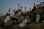Muslim pilgrims pray at top of the rocky hill known as the Mountain of Mercy, on the Plain of Arafat, during the annual Hajj pilgrimage near the holy city of Mecca, Saudi Arabia, Tuesday, May 26, 2026.