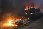 FILE - The Eaton Fire burns vehicles and structures Wednesday, Jan. 8, 2025 in Altadena, Calif.