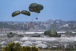 An aircraft airdrops humanitarian aid over Khan Younis, Gaza Strip, May 30.