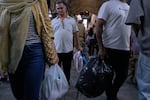 People shop at Tehran's traditional main bazaar, Iran, Saturday, Aug. 8, 2026.