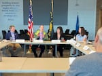 Sen. Ron Wyden (center) discusses the affects of tariffs with Trey Winthrop, CEO of Bob’s Red Mill (left), Tia Sandberg, president of Columbia River Customs Brokers & Forwarders Association (right), Erica Mitchell, chief financial officer at Hood River Distillers (right), and others at the Port of Portland on April 21, 2025.