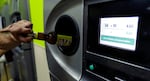 FILE - A bottle is turned in at a BottleDrop Oregon Redemption Center in Gresham, Ore., in this July 31, 2015, file photo. Recyclers can return eligible cans and bottles for 10 cents per container under the Oregon's Bottle Bill.