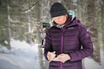 Stephanie Williams records field data in her notebook at one of the camera traps she and collaborator David Moskowitz have set up in an effort to locate Wolverines in the North Cascades.
