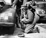 Circa 1940s: Princess Elizabeth changes the wheel of a military vehicle during World War II.