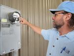 Ashland Conservation Analyst Larry Giardina checks the energy production of Solar Pioneer II.