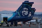 FILE - Alaska Airlines planes are shown parked at gates at sunrise, March 1, 2021, at Seattle-Tacoma International Airport in Seattle.