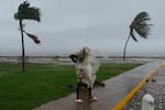 A man walks in Kingston, Jamaica, as Hurricane Melissa approaches, Tuesday, Oct. 28, 2025.