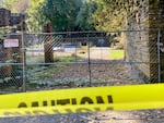Caution tape surrounds the area around Lewis & Clark College’s swimming pool on Aug. 30, 2022. One student died and two were injured Monday night when a free-standing column collapsed. Investigators learned that several hammocks were attached to the column when it collapsed.