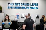 A sign on the wall reads "This site save lives" in Spanish and English at an overdose prevention center.