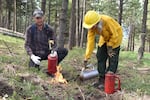 Landowner Deb Evans, right, lights a test fire while Andrew Cart of the Rogue Valley PBA watches.
