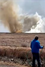 This still image taken from video shows a plume of smoke rising above a plain near Mountain Home Air Force Base, Idaho, where two Navy jets collided at an air show on Sunday, May 17, 2026.
