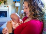 Emily Bendt cradles her 2-week-old infant, Willow, at her home near Portland, Ore., in early October 2023. Bendt, a pediatric nurse, closely followed the recent approval of the RSV monoclonal antibody Nirsevimab but has been unable to find it for her daughter.