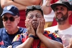 FILE - A fan puts on sunscreen prior to the World Cup Group G soccer match between Belgium and Egypt in Seattle on June 15, 2026.