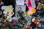 A picture of former One Direction singer Liam Payne sits surrounded by flowers and candles as fans gather outside the hotel where he was found dead after falling from a balcony in Buenos Aires, Argentina, Thursday, Oct. 17, 2024.