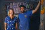Portland artist Mike Bennett and marine biologist Chanel Hason stand in front of Bennett's artwork at their first collaborative project, the Portland "cartoon" aquarium. Bennett and Hason are now co-hosting "The Zooquarium Podcast," a show that helps answer kids' questions about animals.