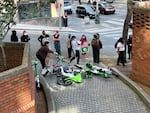 Protesters drop Lime bikes and scooters onto a vehicle ramp at the Henry M. Jackson Federal Building in Seattle on June 10, 2025, hoping to block vehicles from leaving immigration court with detained immigrants.