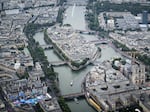 In this aerial view taken from helicopter shows Notre-Dame de Paris Cathedral as delegations boats navigate on the Seine past the Ile de la Cite Island during the opening ceremony of the Olympic Games Paris 2024 on July 26.