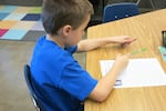 Class of 2025 student Jacob works on a math problem in his 3rd grade classroom at Earl Boyles Elementary School.